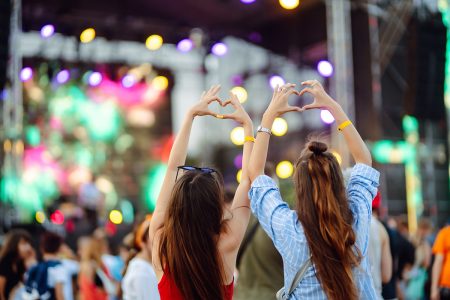 Heart shaped hands at concert, loving the artist and the festiva